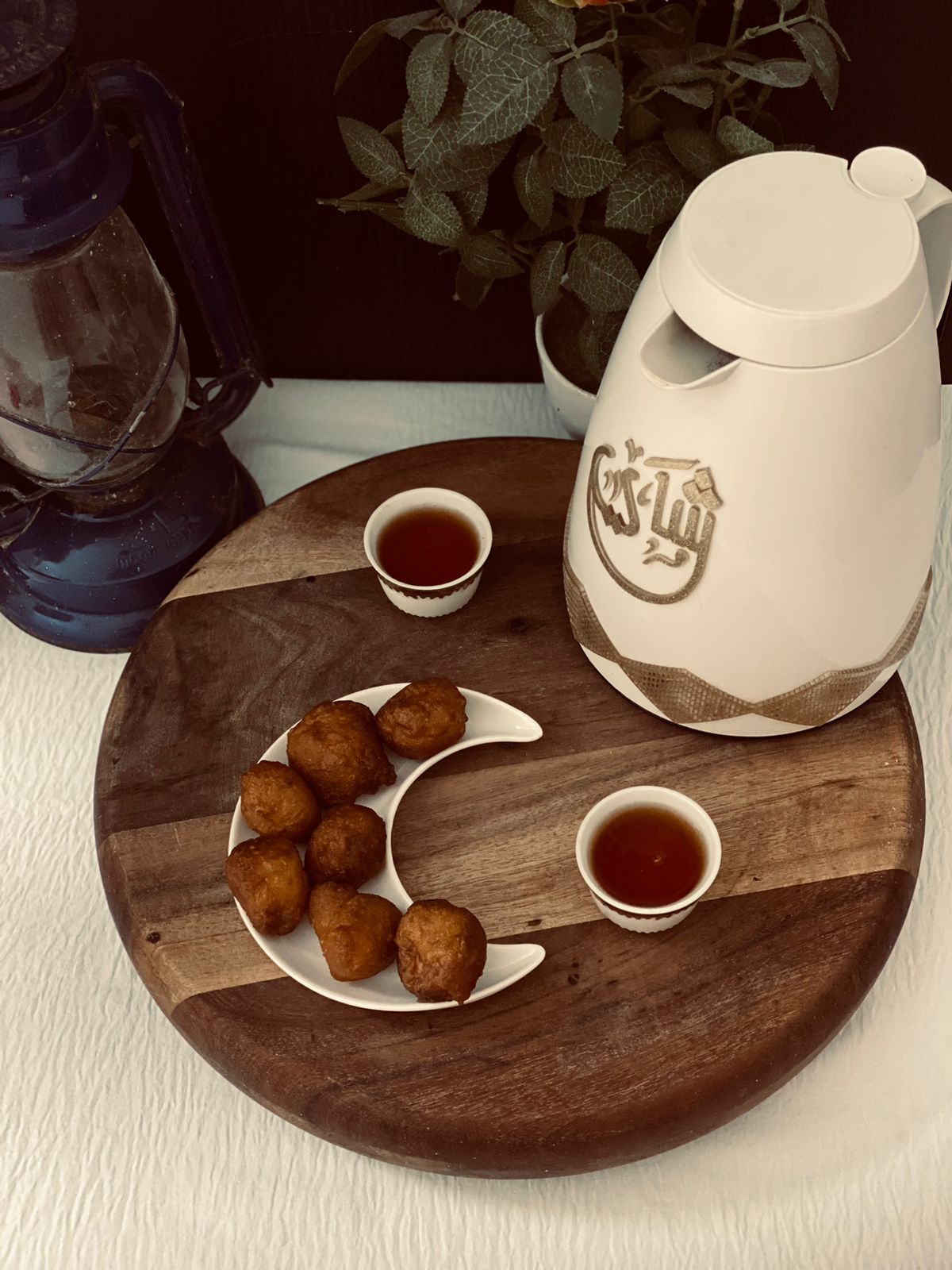 Golden luqaimat served beside Arabic coffee