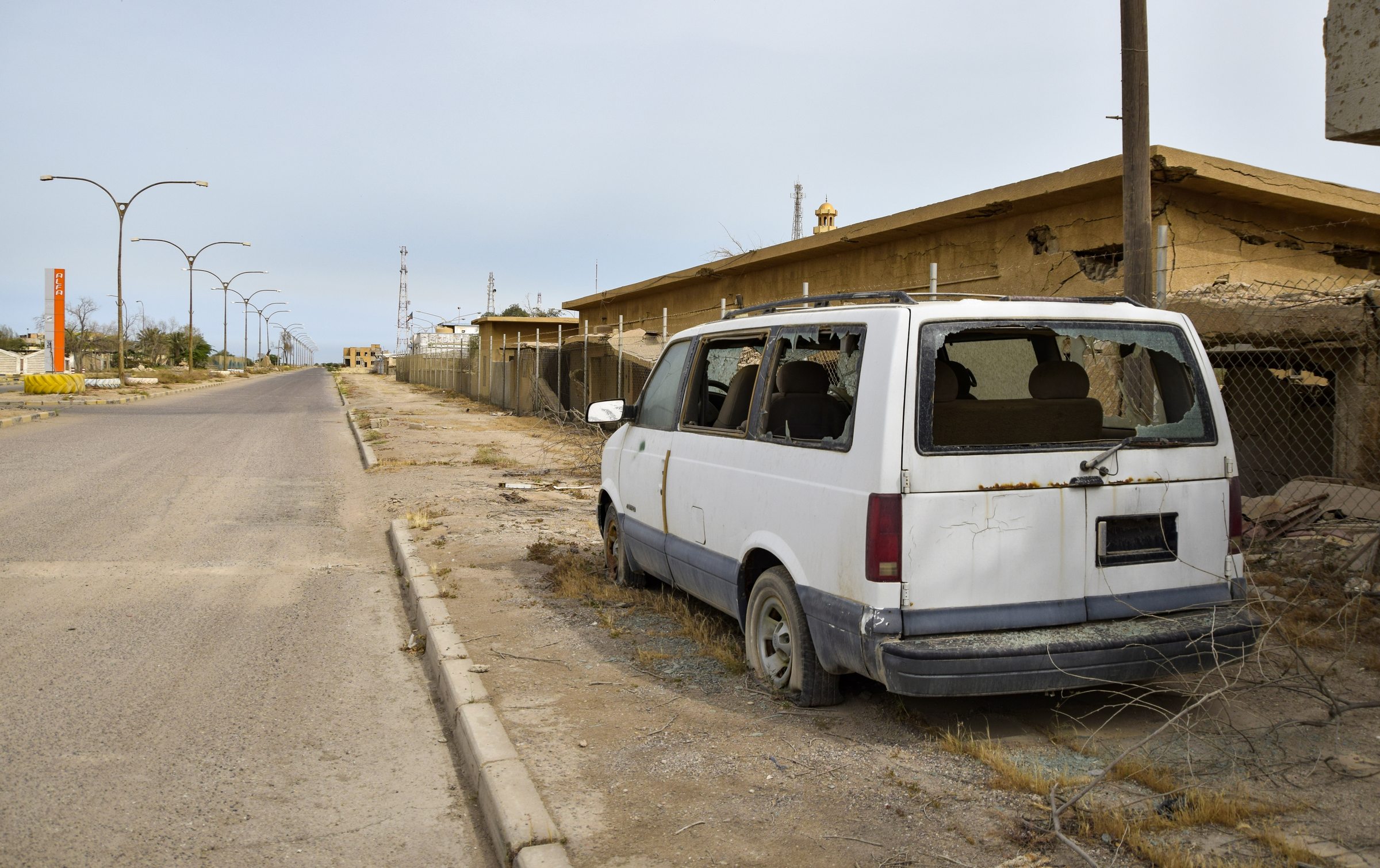 Weathered street and abandoned vehicle in Az Zaur on Failaka Island