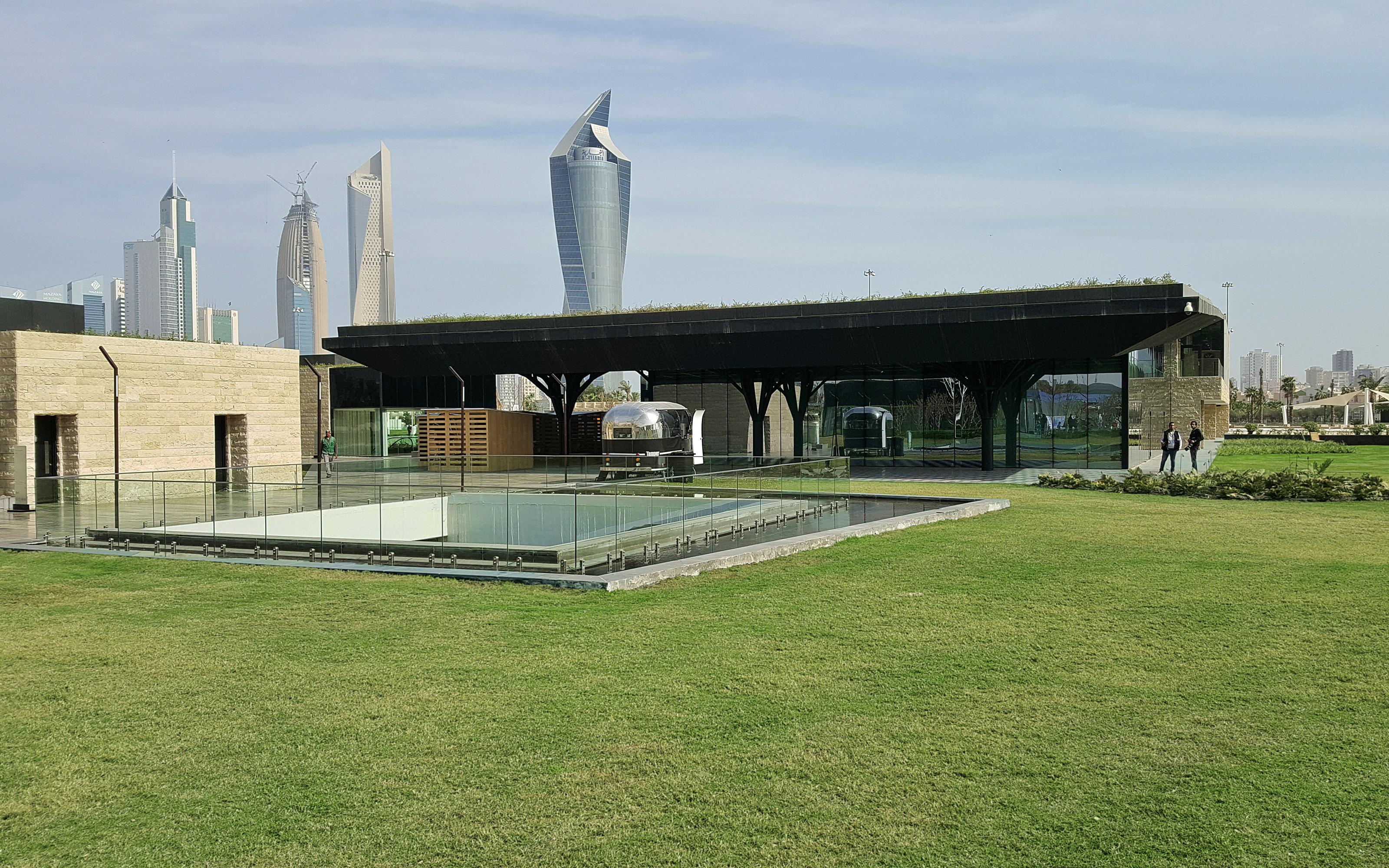 Green-roof pavilion and skyline at Al Shaheed Park