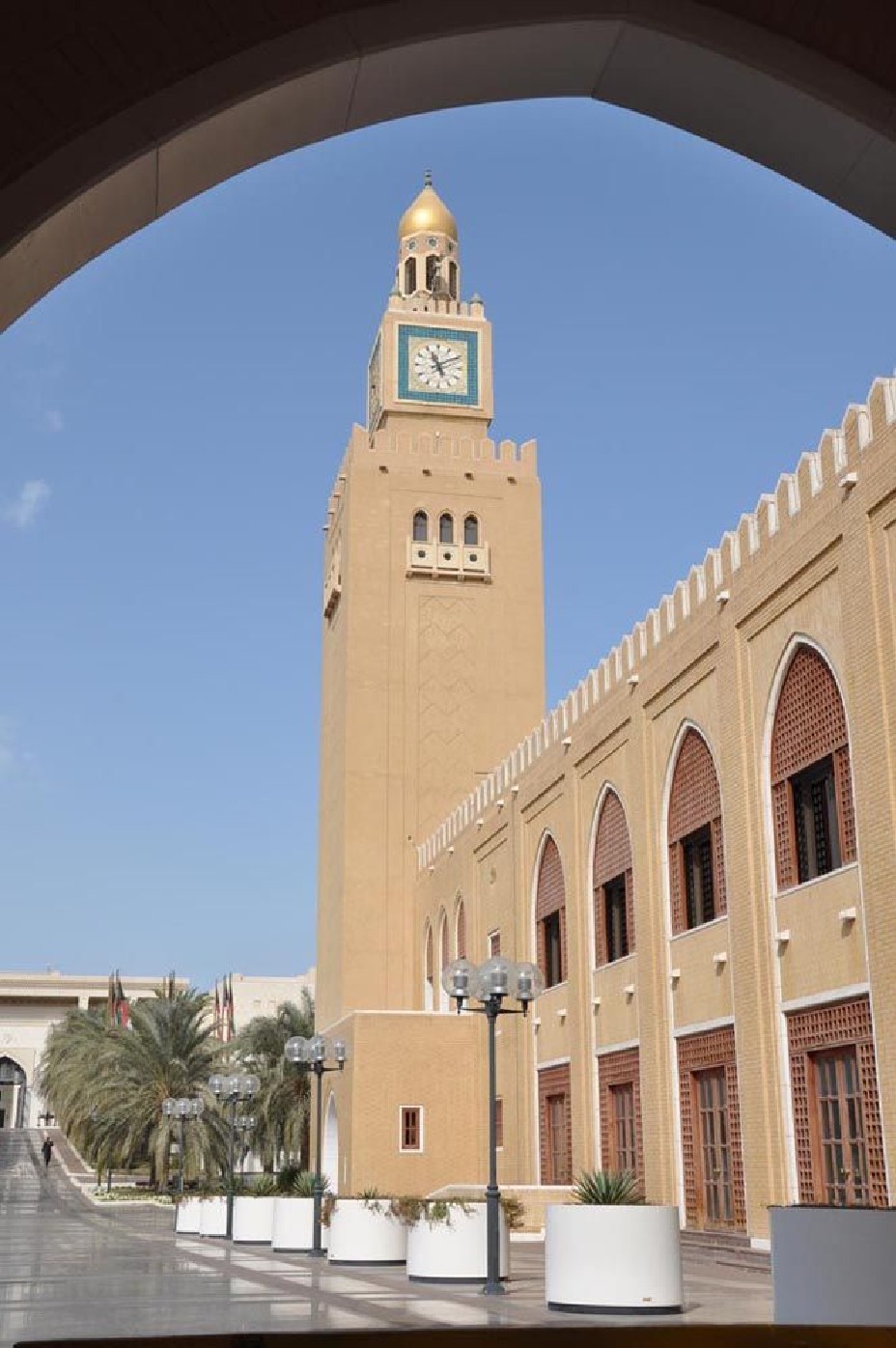 Seif Palace clock tower framed by an arcade