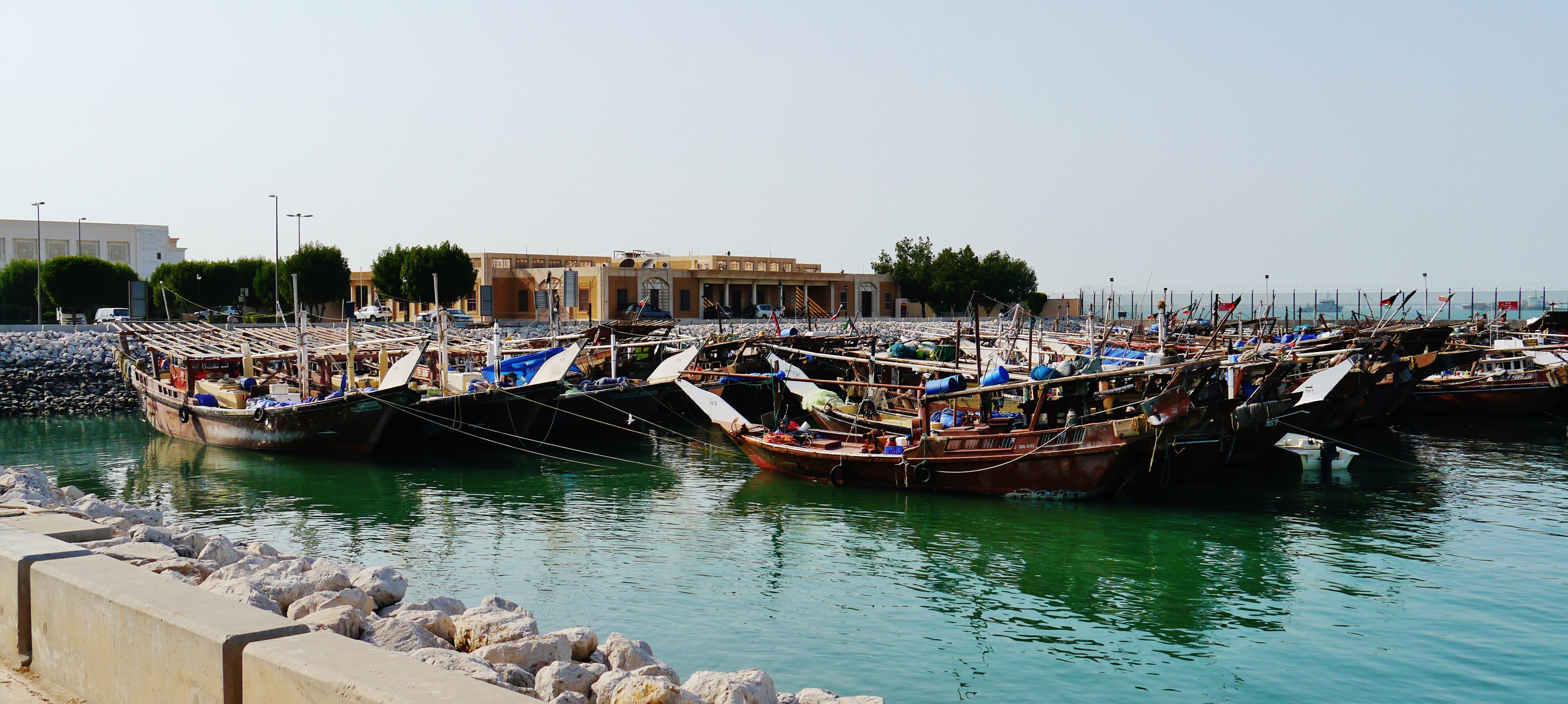 Traditional wooden dhows gathered in Kuwait City’s dhow harbour