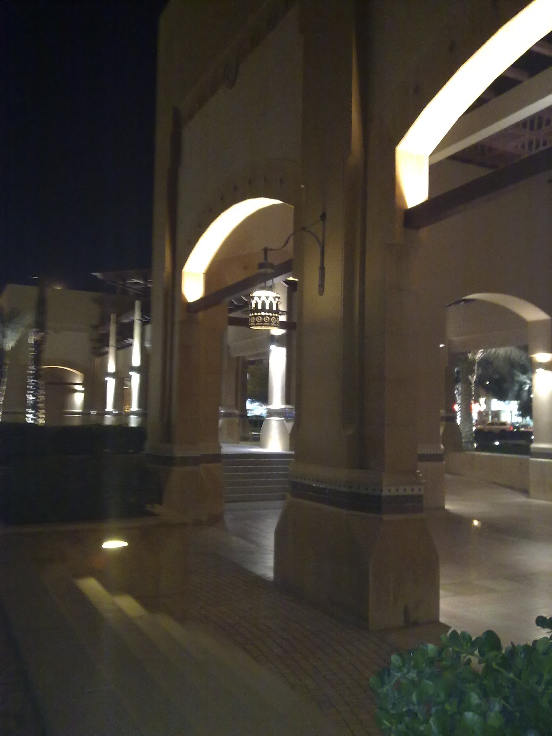 Al Kout Mall illuminated beside the water at night